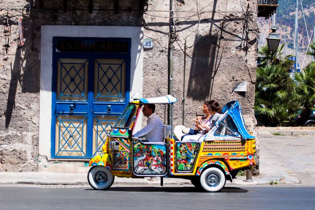 Sicilian Ape motorbike with tourists in Palermo