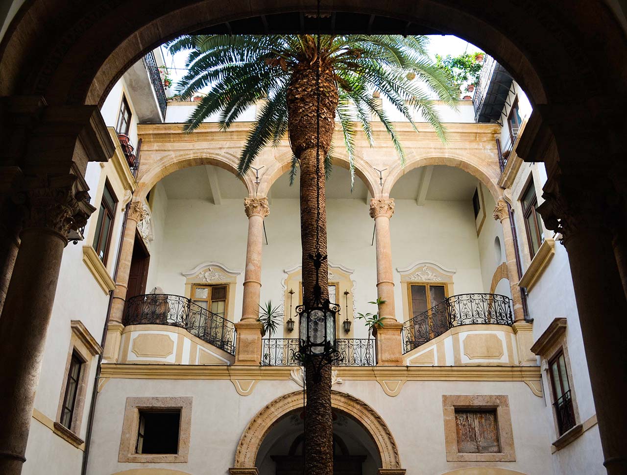 internal courtyard of Palazzo Castrone - Garden of S. Ninfa in Palermo, with a central palm tree