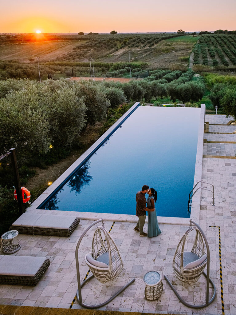 couple kissing by the pool immersed in the Sicilian countryside
