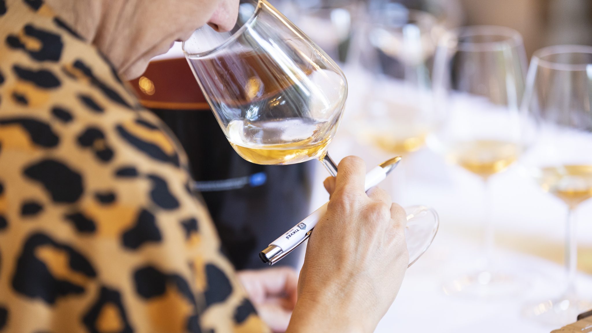 moments of Sicilia DOC Tasting, woman smelling a glass of wine