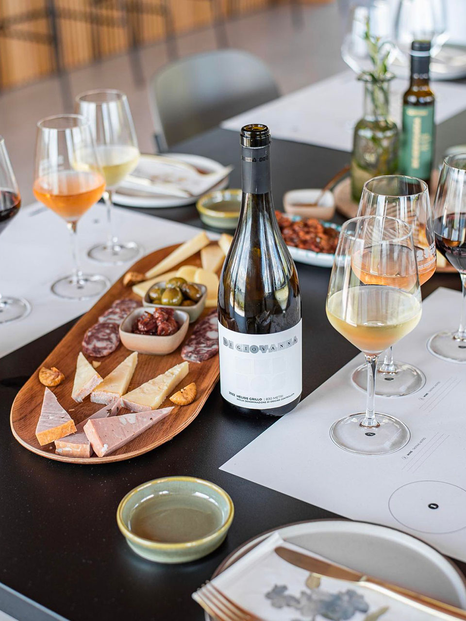 table with wine, cured meats and cheeses