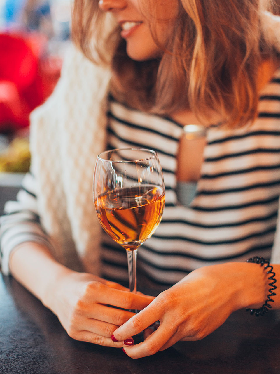 woman holding a glass of Marsala wine