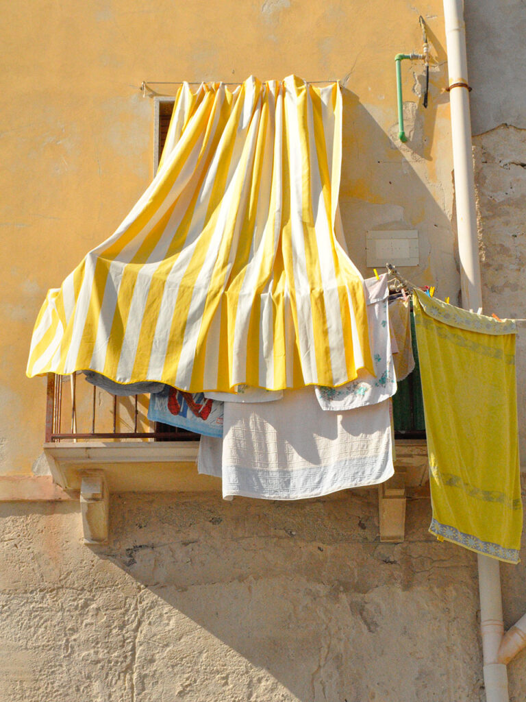 balcony with white and yellow striped awning